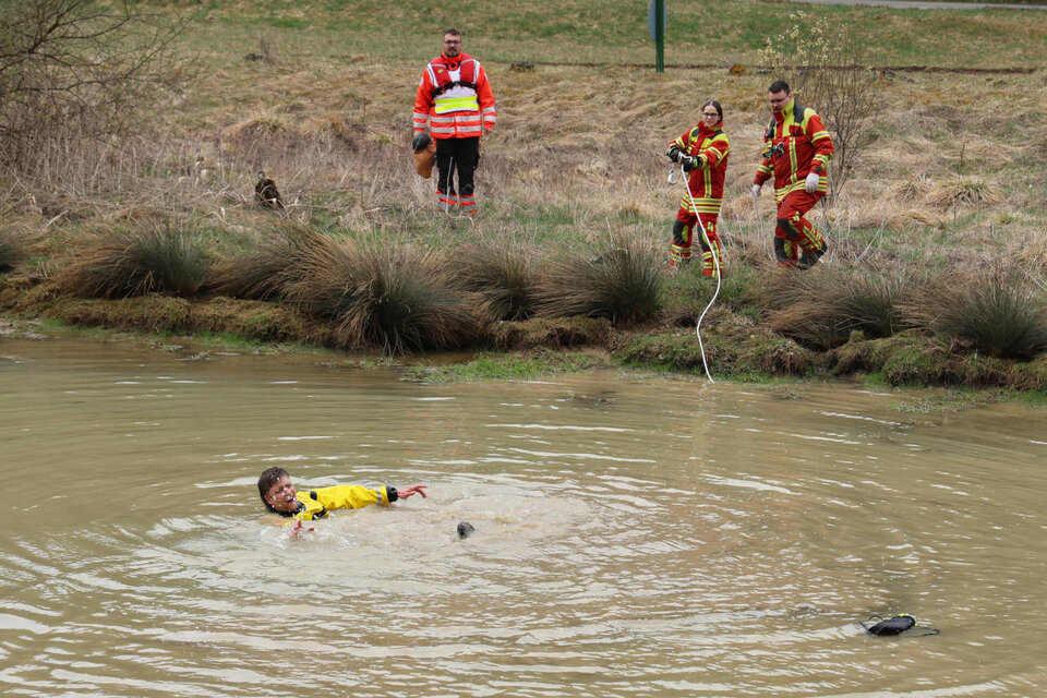 Feuerwehrleute werfen dem Verunglückten ein Rettungsseil zu (Station "Badewanne").